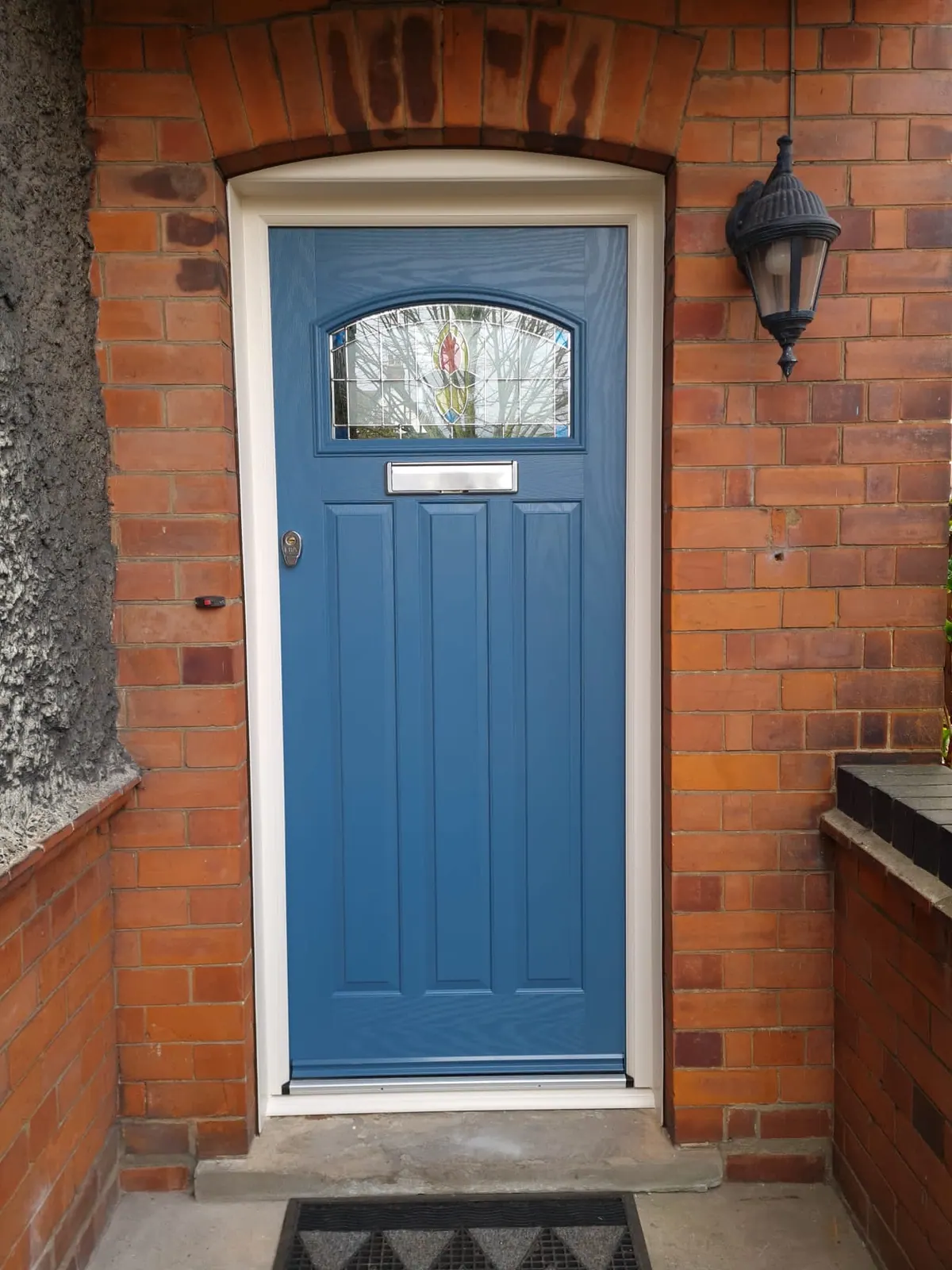 PM Windows installation: A blue composite door with decorative glazing