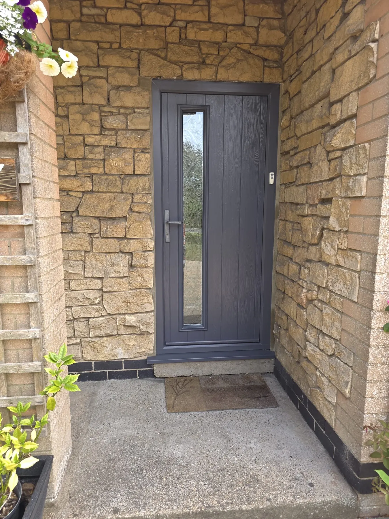 PM Windows installation: Dark framing against natural stone