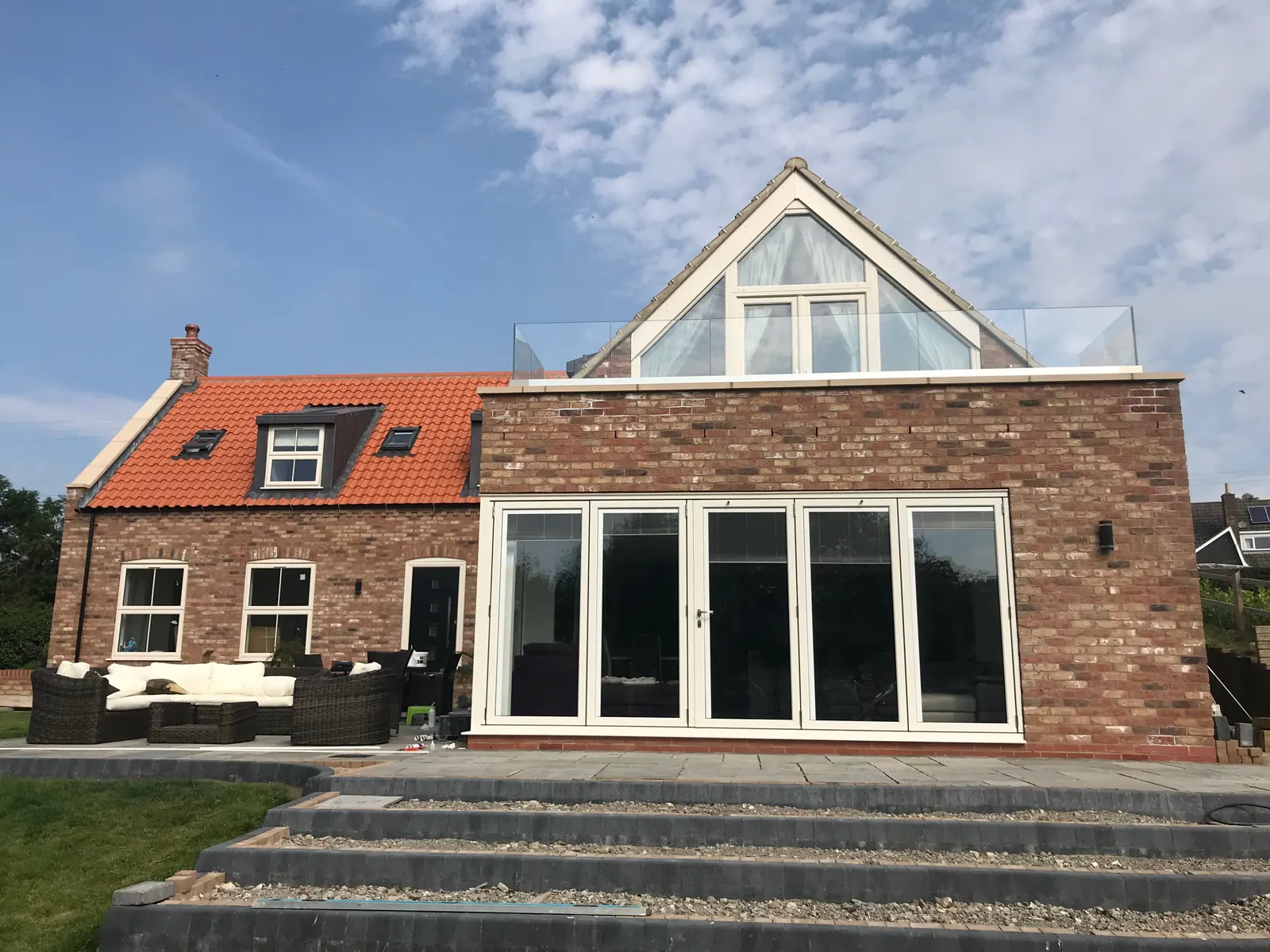 PM Windows installation: Bi-fold doors beneath a glazed gable