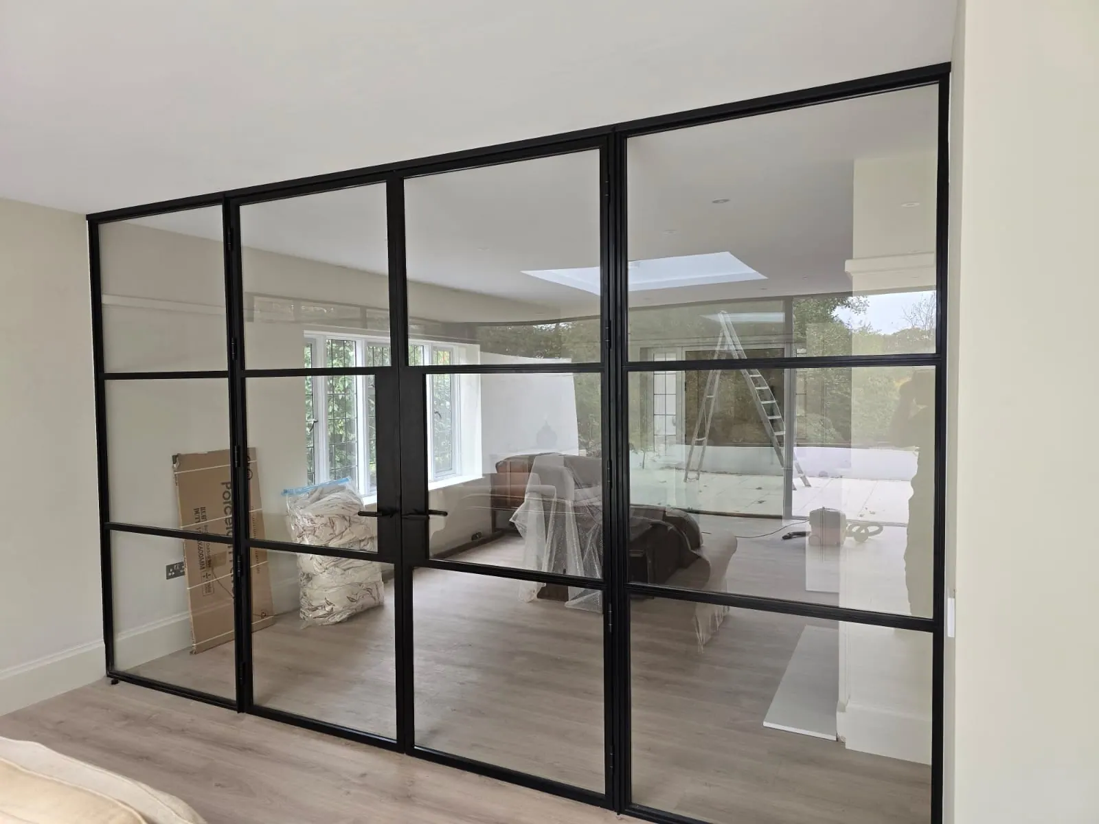 PM Windows installation: A glazed partition shaping an open-plan room