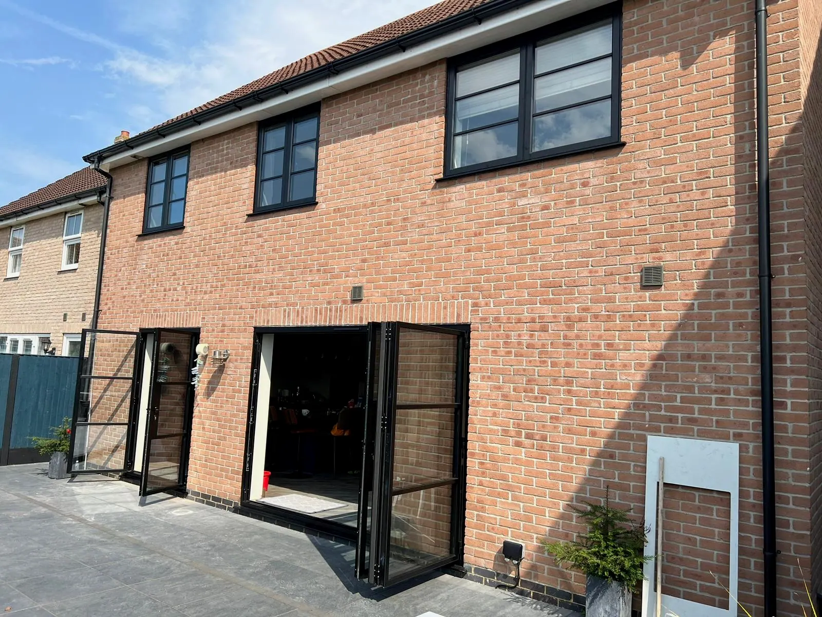 PM Windows installation: Steel-look doors across a complete rear elevation