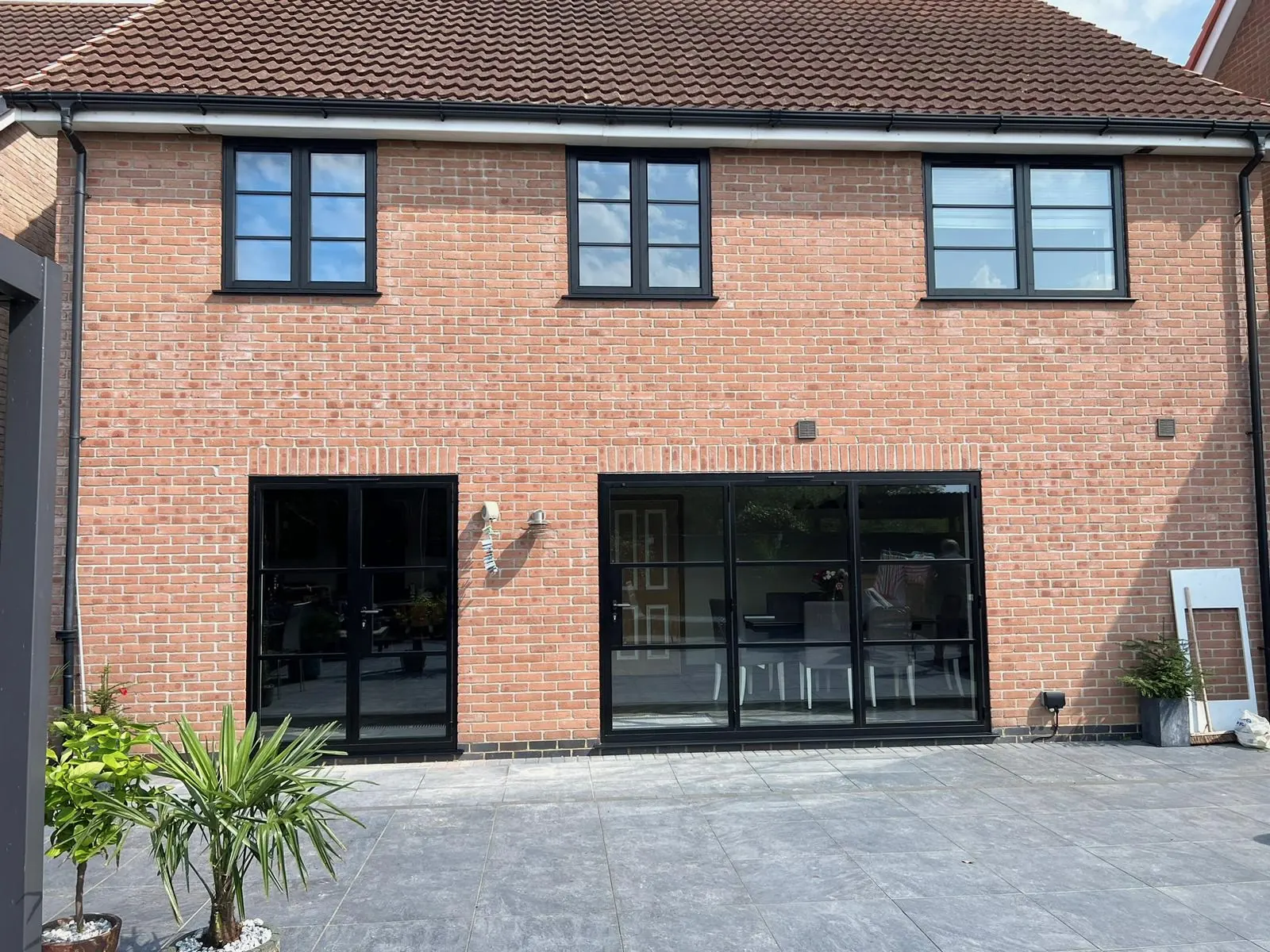 PM Windows installation: Steel-look rhythm across the rear elevation