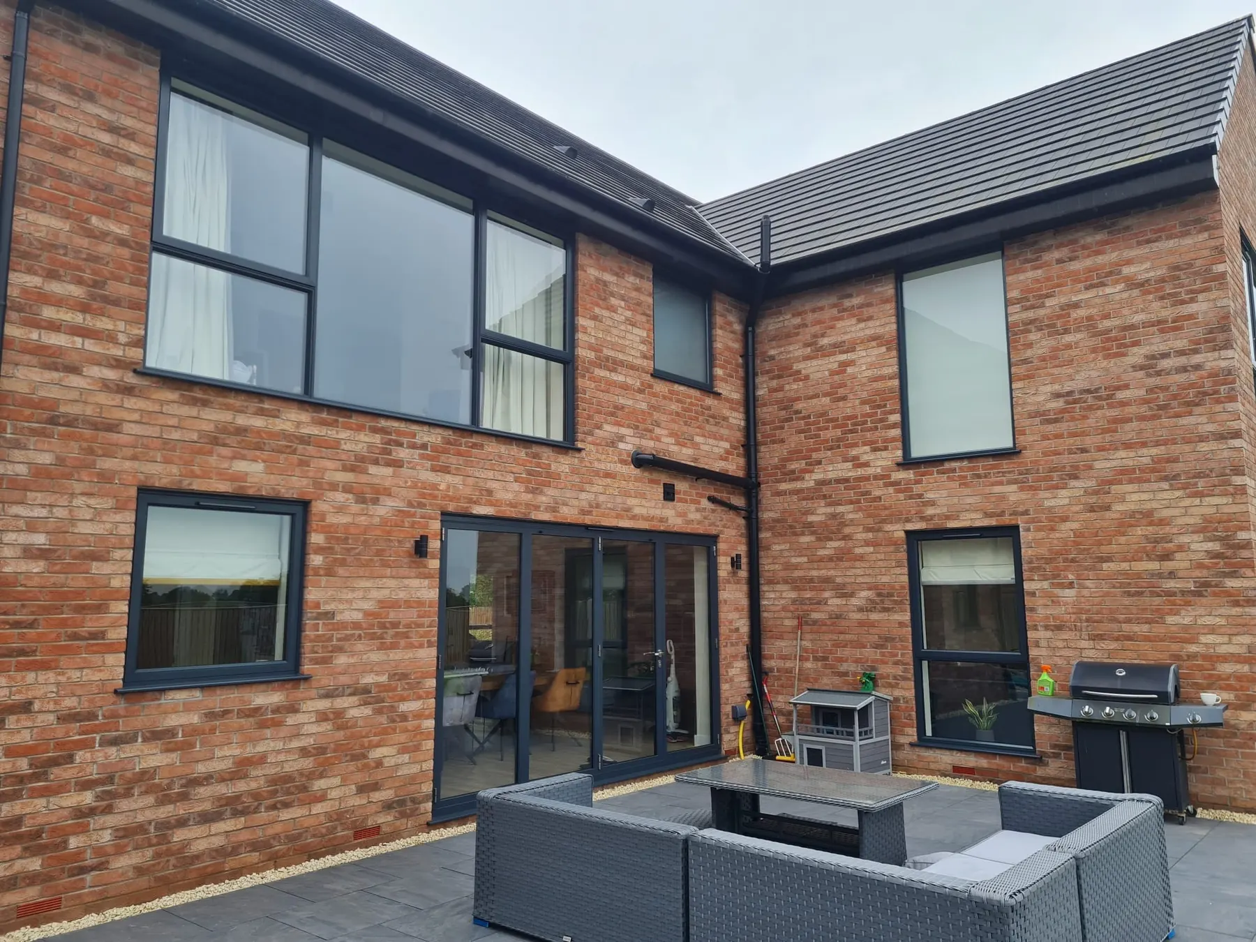 PM Windows installation: Dark frames against warm brickwork