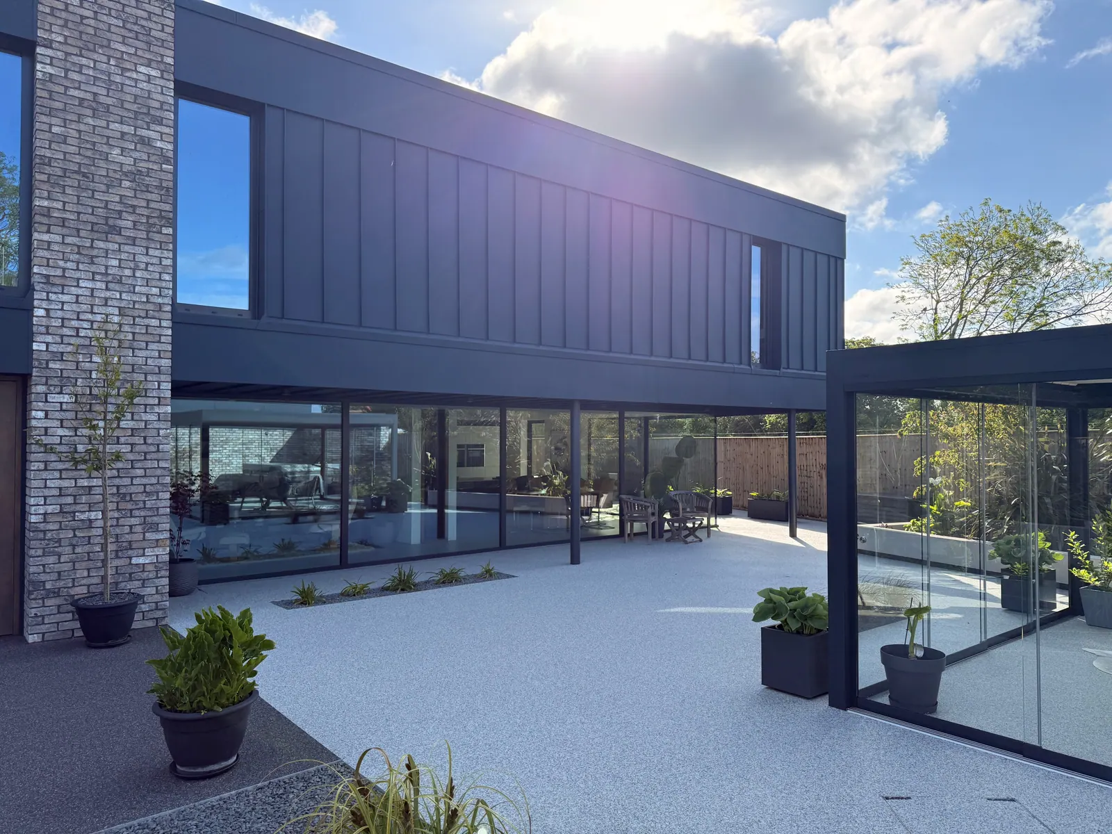 PM Windows installation: Broad glazing beneath a modern overhang